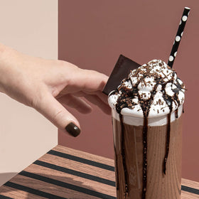 Pouring Keto Chow Chocolate shake for a convenient keto lunch