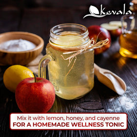 Drizzle of Kevala vinegar over a salad showcasing versatility.