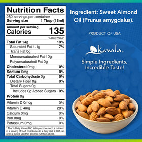 Pouring Kevala Almond Oil to drizzle over salad for subtle flavor.