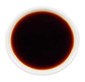 Kikkoman bottle beside stir-fry pan adds quick flavor boost
