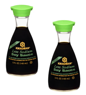 Kikkoman Less Sodium Soy Sauce dispenser bottle 2-pack on kitchen shelf for quick, balanced flavor boosts.