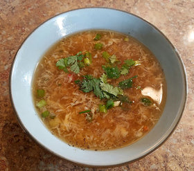 Steaming bowl of Kikkoman soup with vegetables shows versatile add ins.