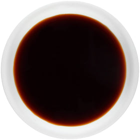 Kikkoman Tamari glaze on a sizzling stir-fry dish.
