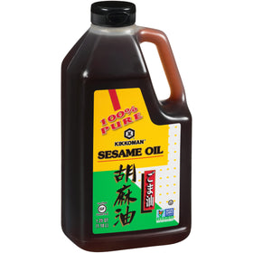 Kikkoman toasted sesame oil being poured during a sizzling stir fry.