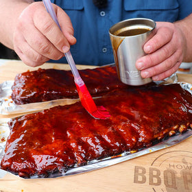 Killer Hogs hot sauce on grill setup for tangy barbecuing