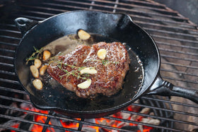 Killer Hogs steak rub on grill for mouthwatering sear.
