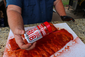 Killer Hogs The BBQ Rub on ribs on the grill for deep color