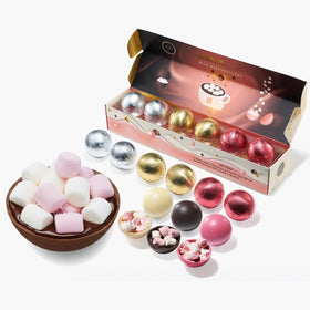 Kiri & Sons hot chocolate bombs with white shell dissolve in milk for a creamy drink.