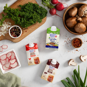 Kitchen Basics Unsalted Vegetable Stock carton pour into a pot for rich flavor.