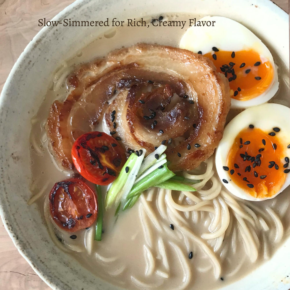 Bowl of Kitchen Kurume Tonkotsu ramen with rich, creamy broth on display.