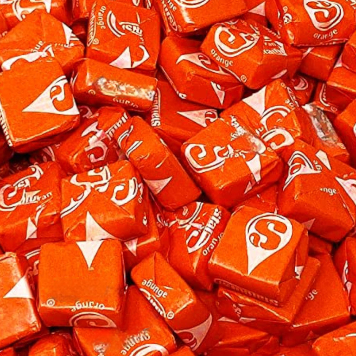 Individually wrapped KLUB BULK Orange Str Burst candies for Halloween favors.