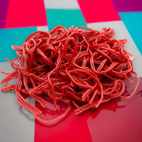 KLUB BULK red strawberry licorice laces closeup showing soft, chewy texture and vivid flavor.