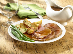 Knorr Brown Gravy served over meat for a home style plate