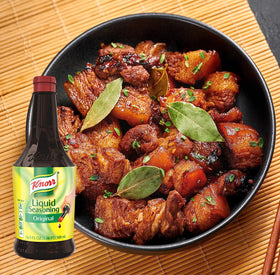 Pouring Knorr Liquid Seasoning Original to flavor a dish.