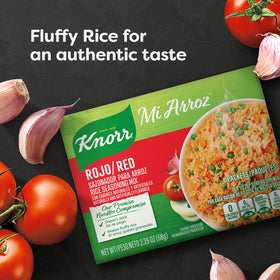 Knorr Mi Arroz red rice seasoning mix being used to cook rice in a pan