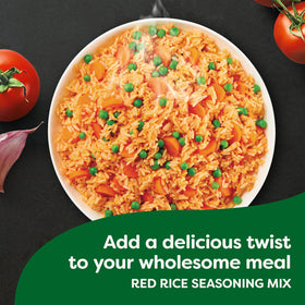 Pouring Knorr Mi Arroz red rice seasoning mix into a pot for flavorful rice