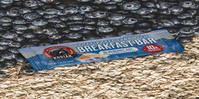 Kodiak Cakes Blueberry Oat Bar cross-section reveals fruit-filled, moist interior