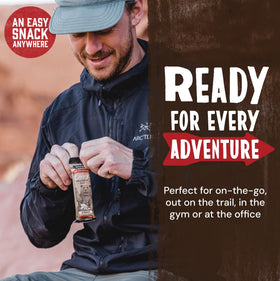 Trail-ready Kodiak Cakes S'mores bar beside a water bottle for outdoor snacking.