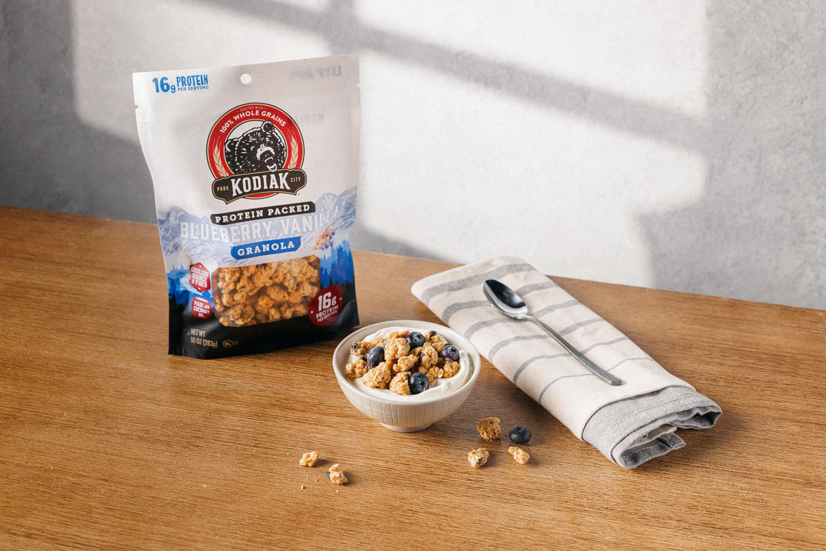 Kodiak Cakes Granola Blueberry Vanilla bowl with yogurt, crunchy topping option.