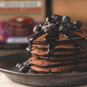 Cooked Kodiak Cakes pancakes topped with fruit for a protein-rich breakfast.