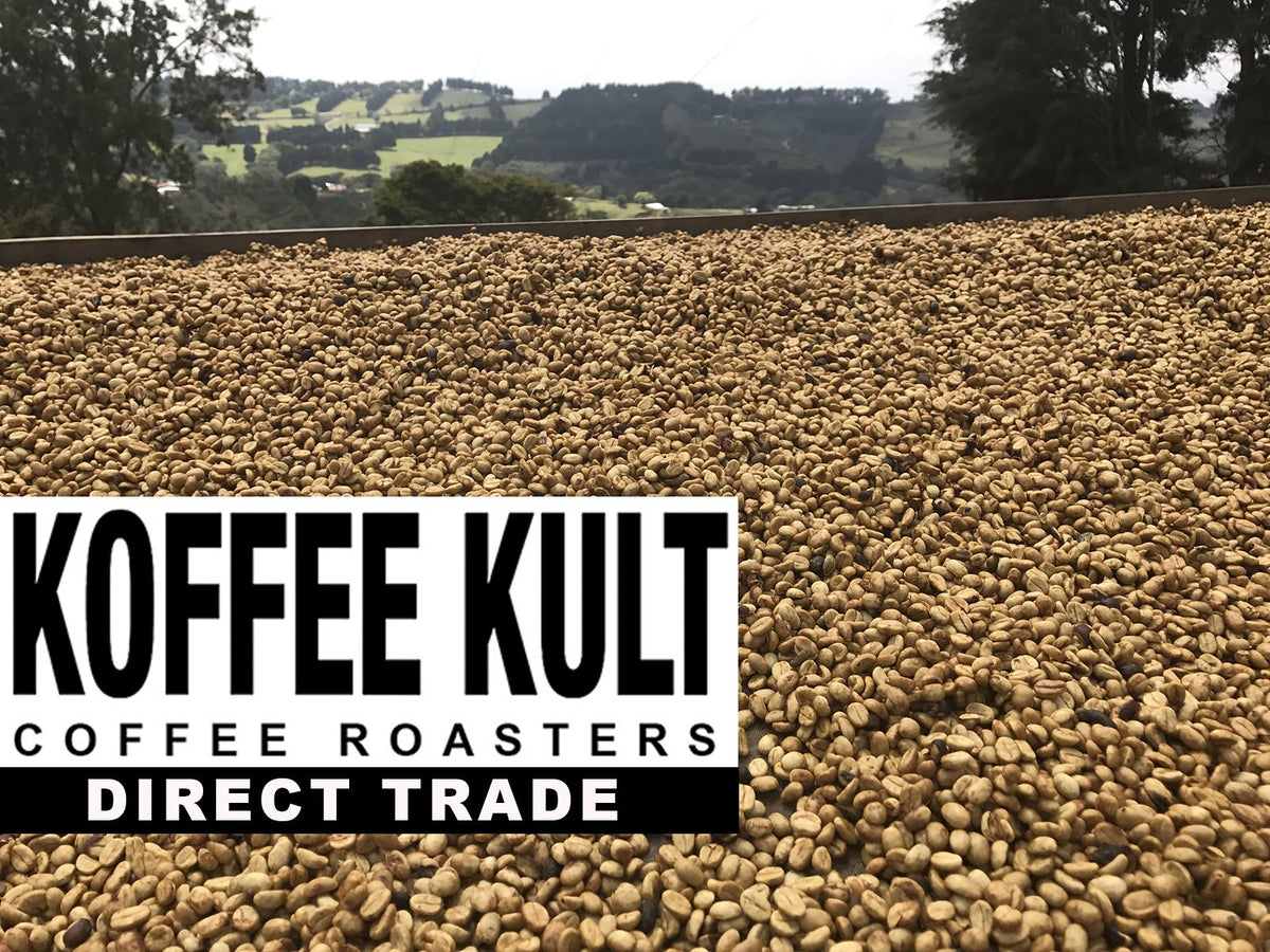 Koffee Kult Thunder Bolt whole beans beside grinder.