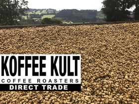 Koffee Kult Thunder Bolt whole beans beside grinder.