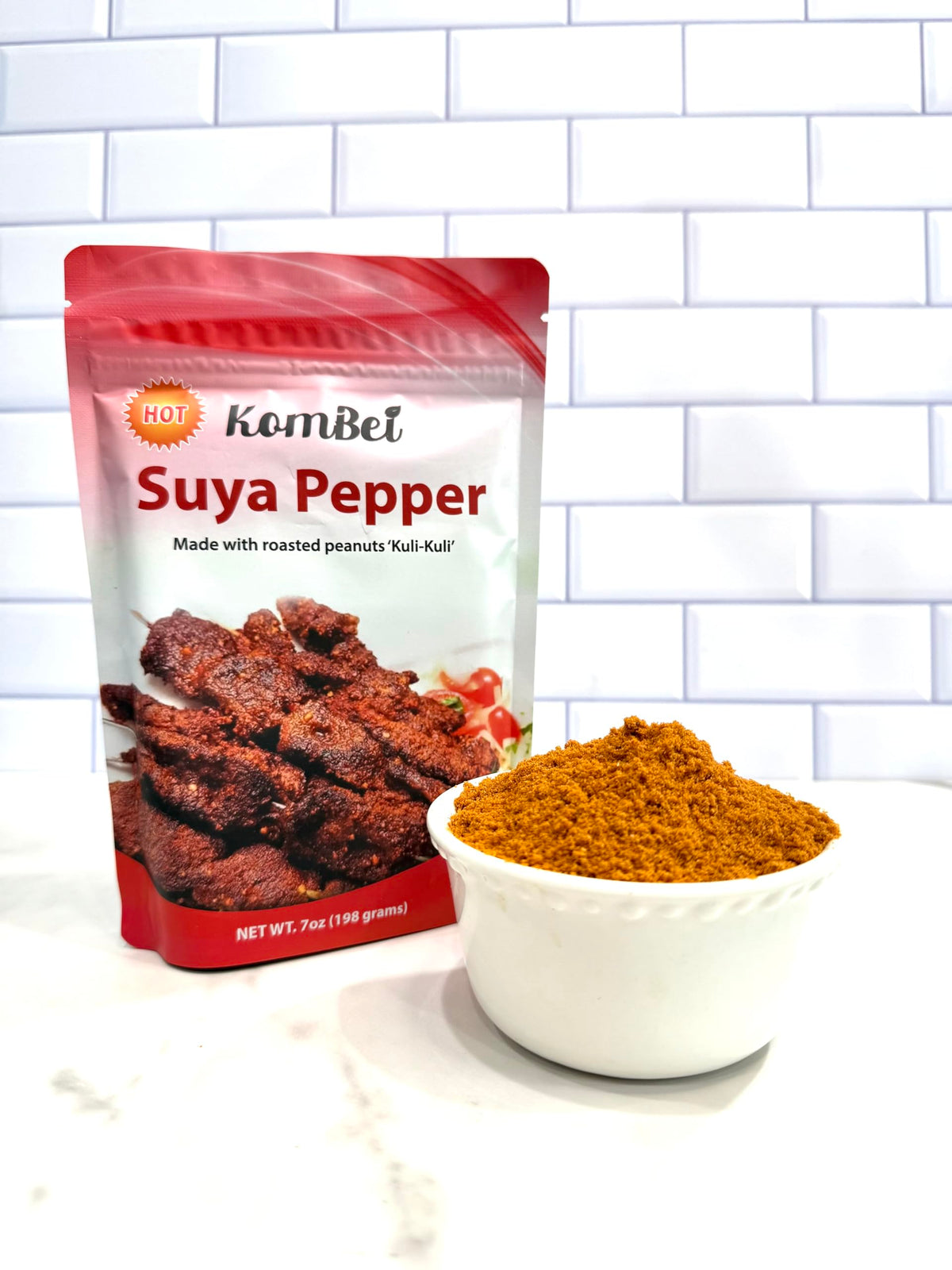 KomBei Suya Spice HOT pouring action highlights cayenne heat for vibrant grills and kebabs.