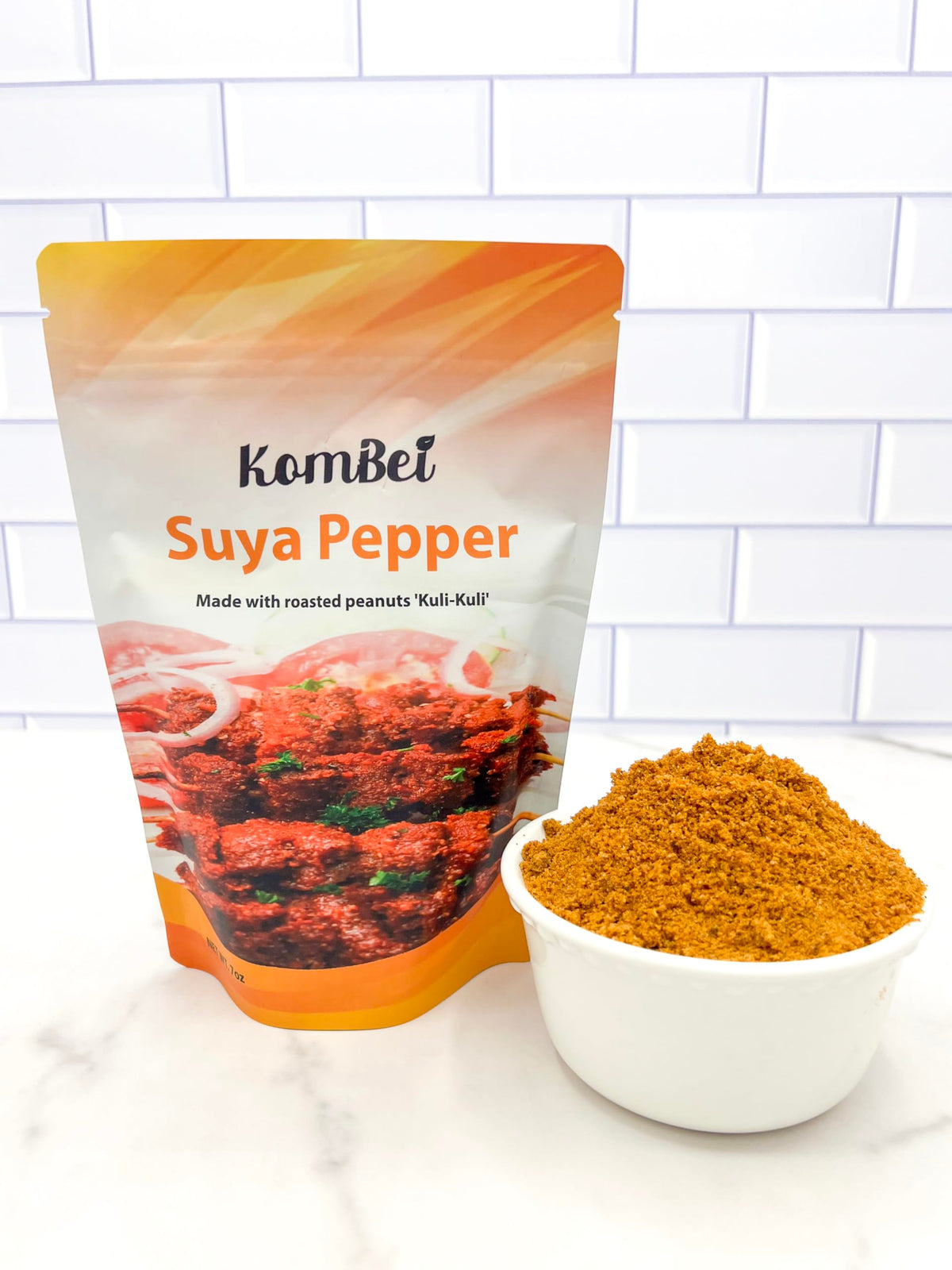 KomBei Suya Spice sprinkled on chicken for bold grilling flavor.