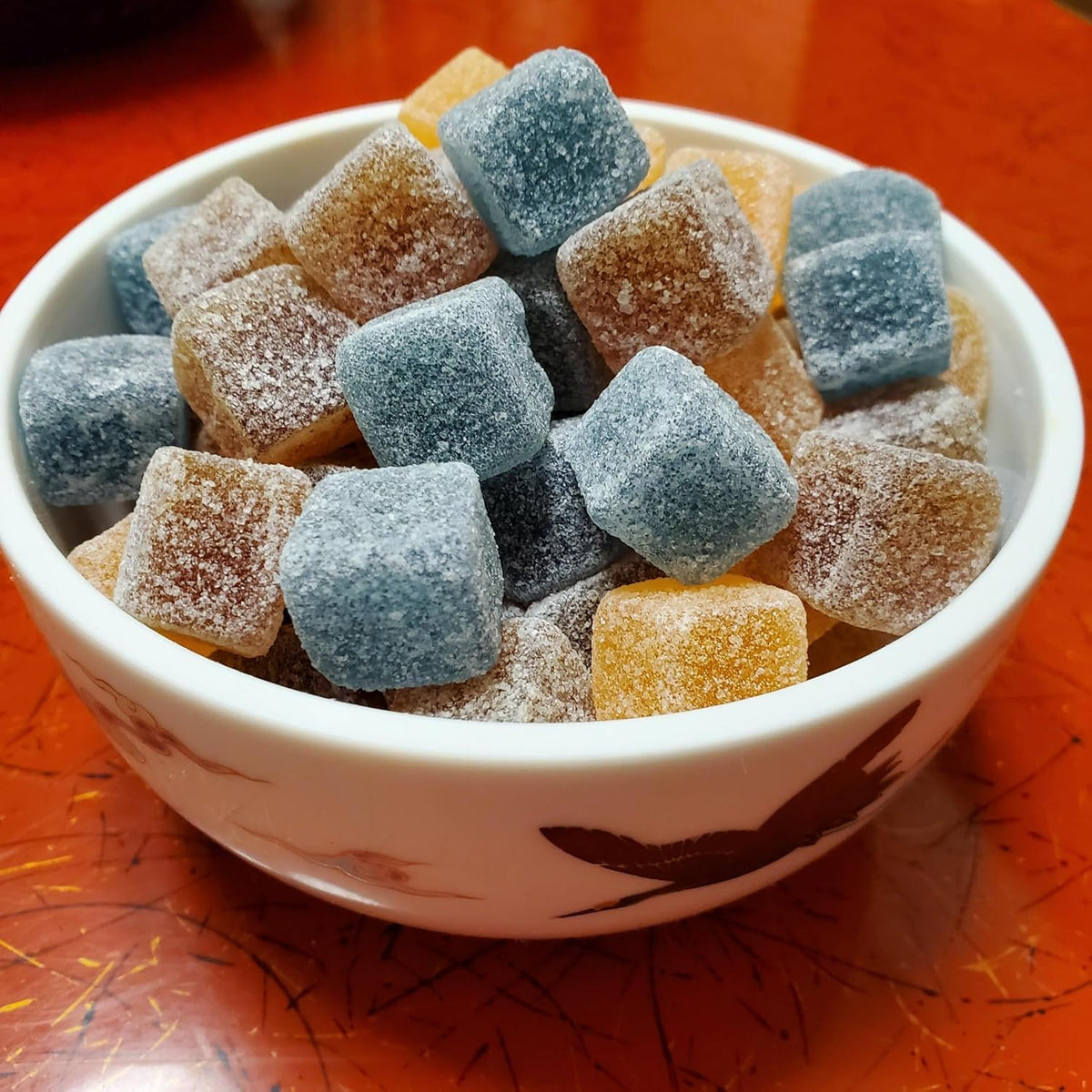 Konbini Japan powder coating closeup reveals sweet-sour dust on grape gummy.