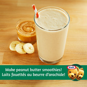 Kraft Peanut Butter Smooth 2 kg jar being stirred, showcasing creamy texture for recipes.