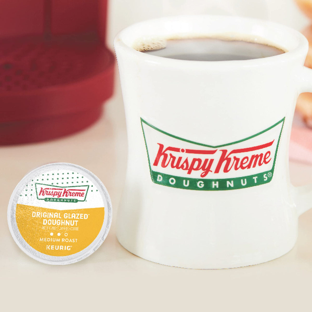 Krispy Kreme box and cup on a cafe-style table inviting a treat moment.