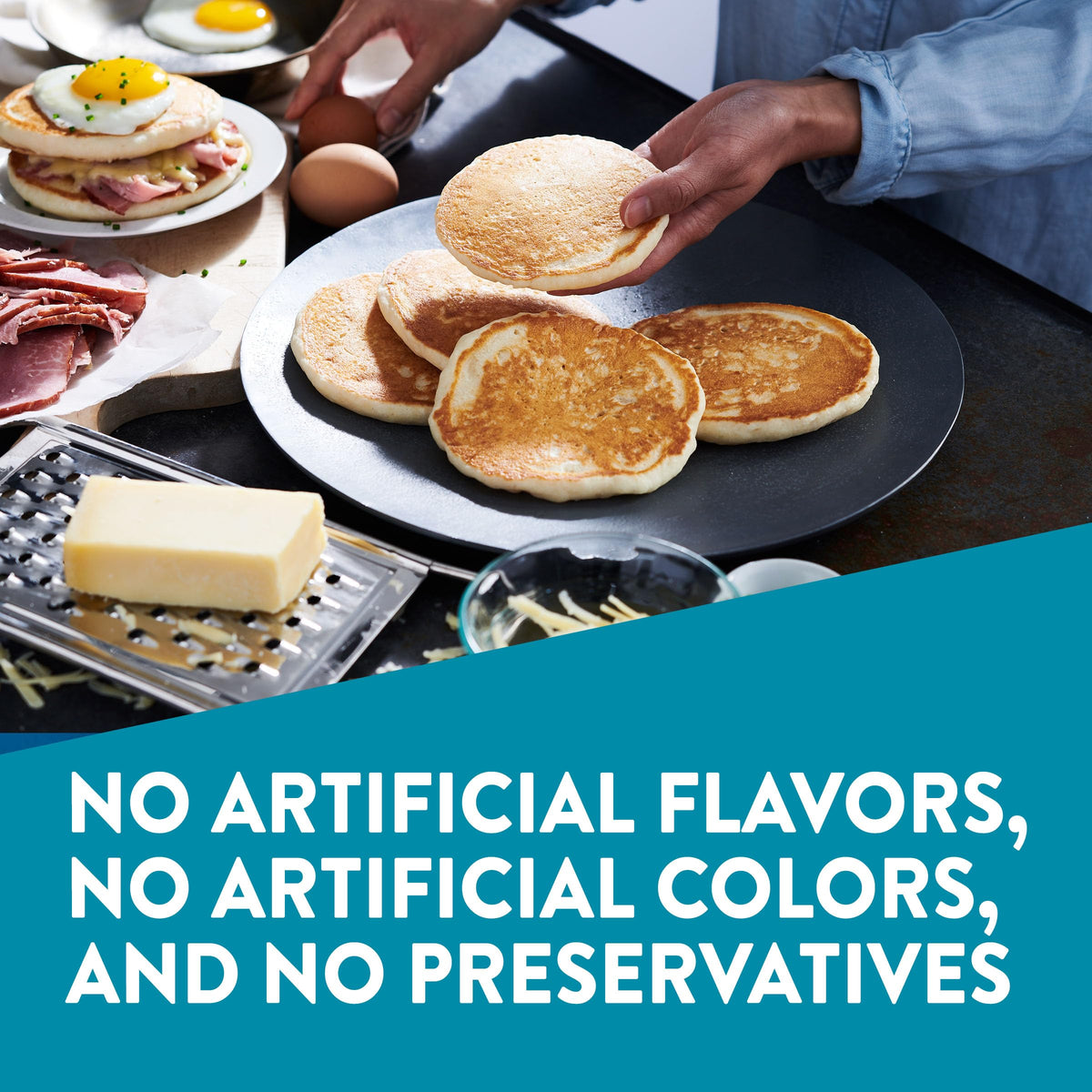 Krusteaz Protein Pancake Mix – golden-brown pancakes cooking on a griddle.