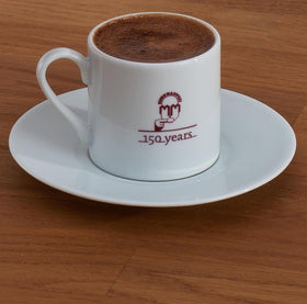 Foamy Turkish coffee cup capturing signature crema.