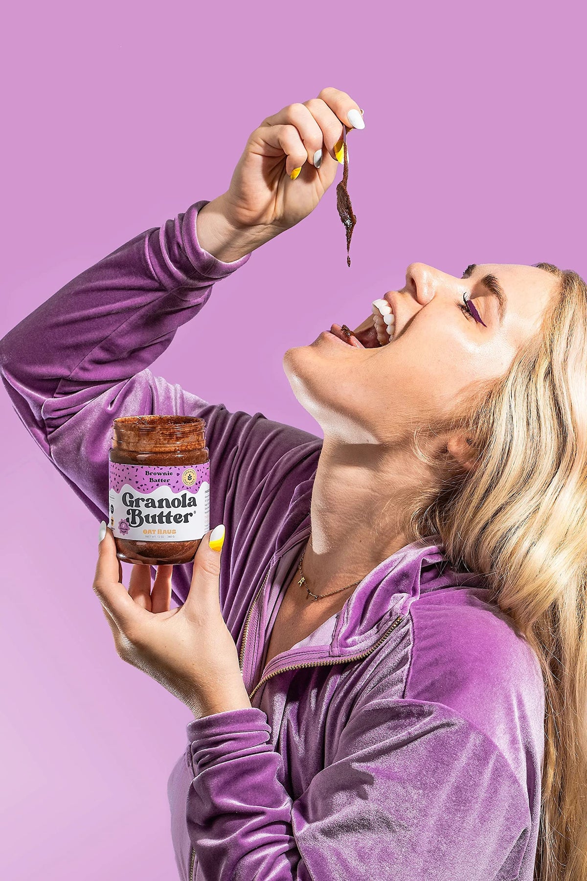 KWEEN Oat Haus Brownie Batter Granola Butter being scooped for a quick snack