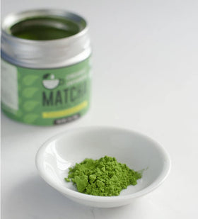 Kyoto Dew Matcha powder in bowl with whisk shows vibrant color and texture.