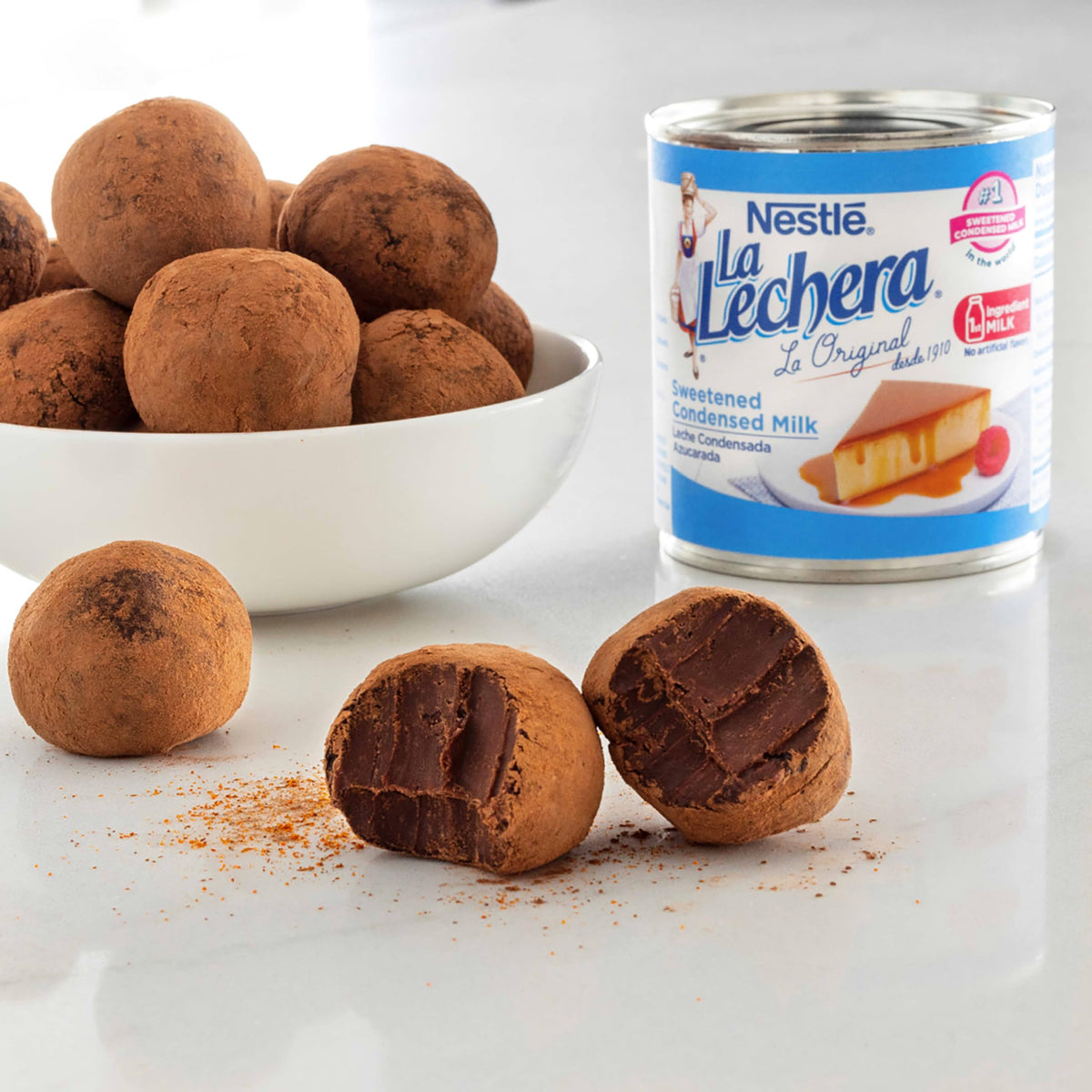 Pouring La Lechera condensed milk from the can for coffee or desserts.