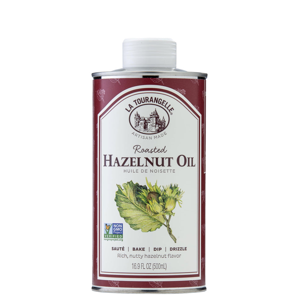 La Tourangelle Roasted Hazelnut Oil bottle pour enhances salads with nutty aroma.