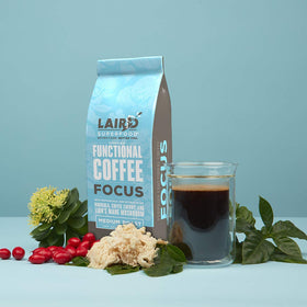 Kitchen counter with Focus Coffee package beside a mug.