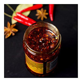 Lao Gan Ma Spicy Chili Crisp spoon in jar for easy serving.