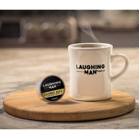 Fair Trade and Orthodox Union Kosher labels on Laughing Man packaging.