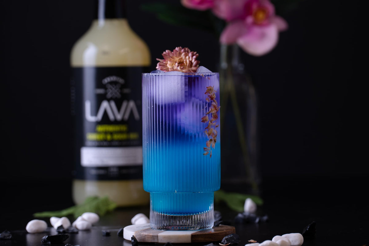 Bar scene featuring a 1-liter bottle of LAVA Blue Curacao Syrup.