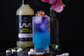 Bar scene featuring a 1-liter bottle of LAVA Blue Curacao Syrup.