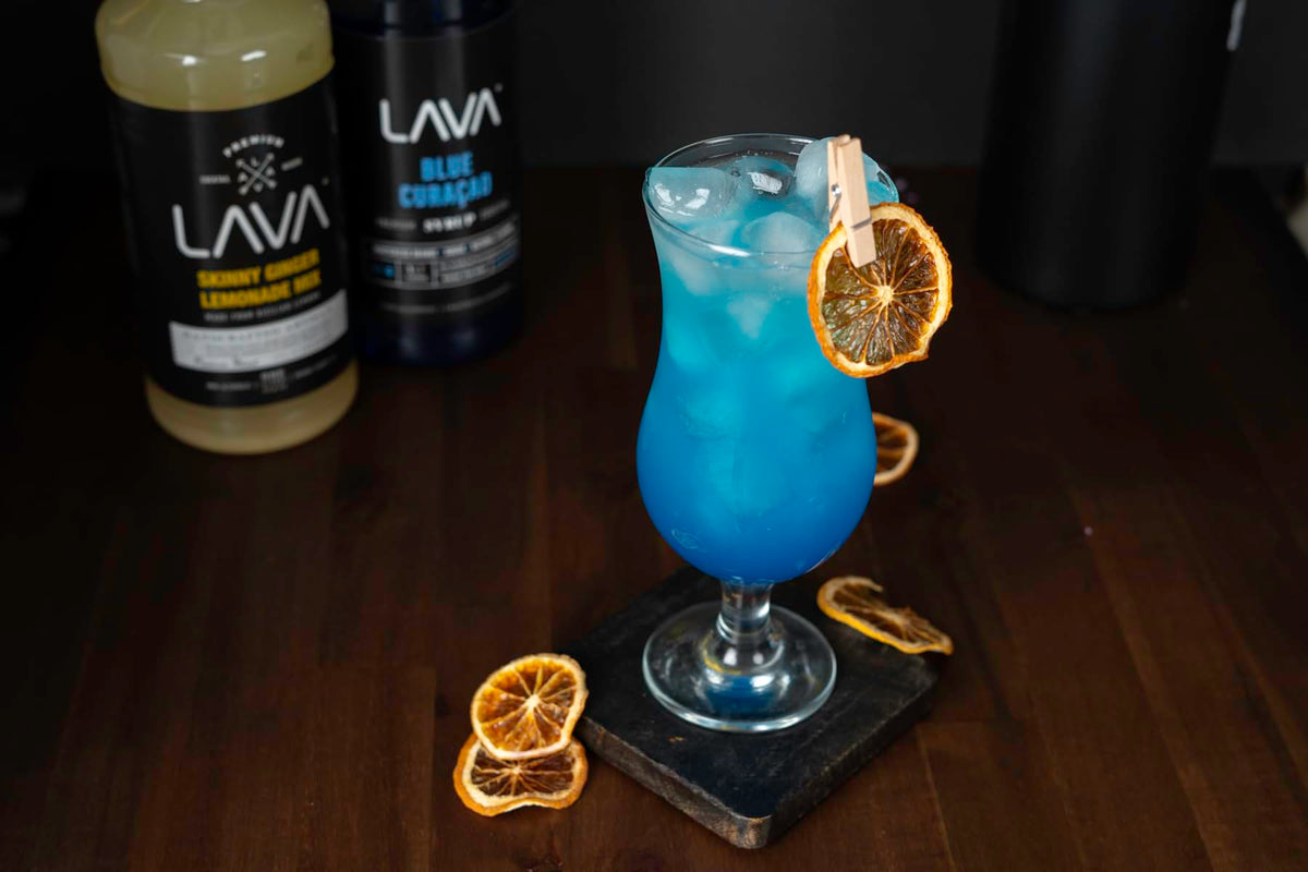 Glass with blue lagoon made using LAVA Blue Curacao Syrup.