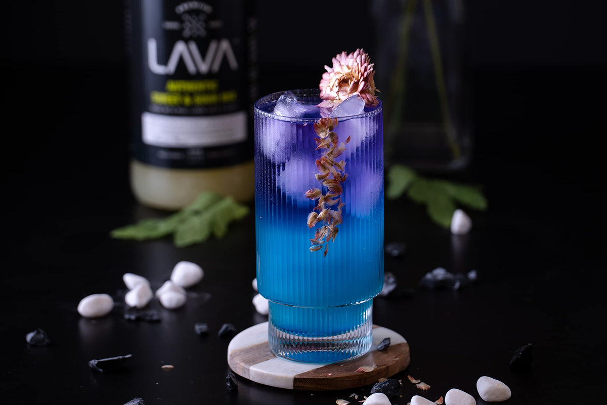 Pouring LAVA Blue Curacao Syrup creates a vivid blue lagoon cocktail.