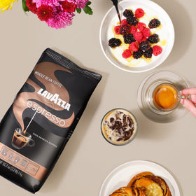 Lavazza Espresso beans beside a moka pot for traditional stovetop coffee.