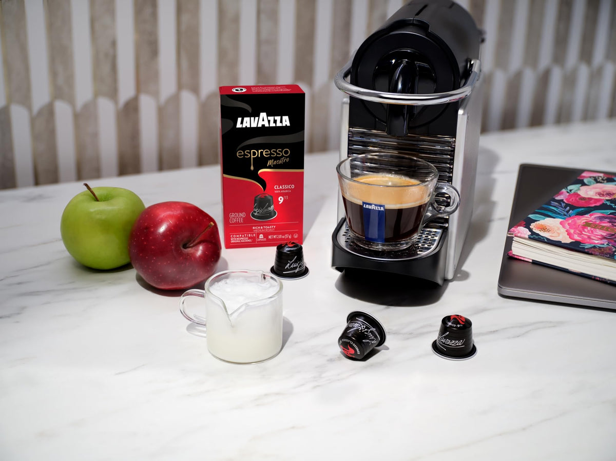 Lavazza Classico capsules on kitchen counter with a steaming cup