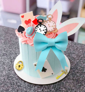 LaVenty Alice key cake topper sparkles as a magical party accent.