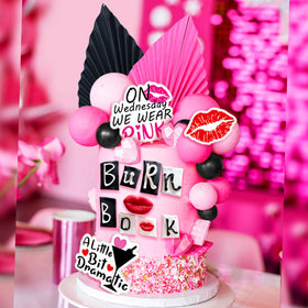 LaVenty Black palm leaf cake decoration provides bold contrast.