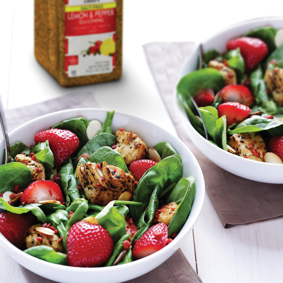 Ready-to-use Lawry's Salt-Free Lemon & Pepper seasoning sprinkled on prepared dishes