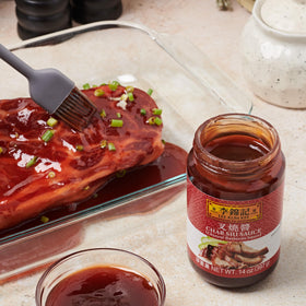 Lee Kum Kee Char Siu sauce brushed on skewers for grilling.